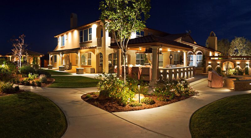 A house with outdoor lighting at night