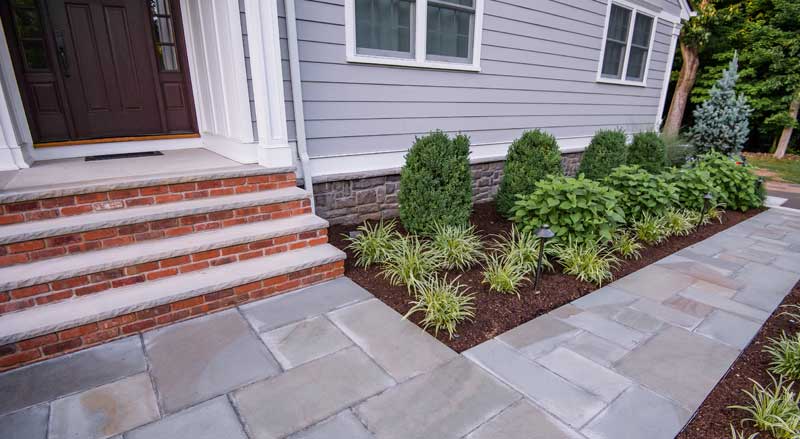 Stone walkway and brick entry steps as part of a permitted residential landscaping upgrade