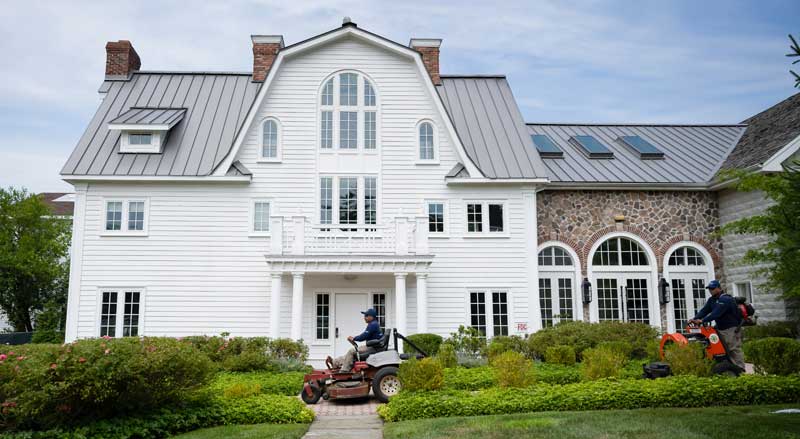 Landscape Solutions team maintaining an upscale landscape showcasing full-service landscape maintenance for residential and commercial properties