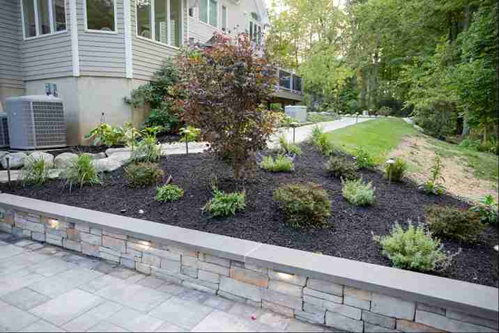 Managing changes in elevation with stone retaining wall and patio