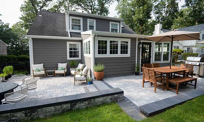 A multi-level patio with cooking, dining, and entertaining areas