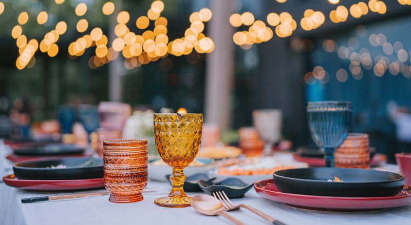 An outdoor dinner table set for a meal