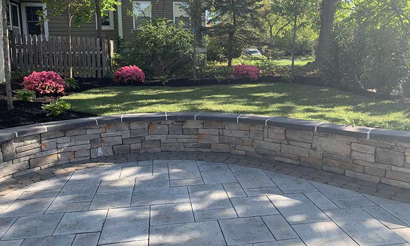 Patio pavers make a durable patio with sitting wall