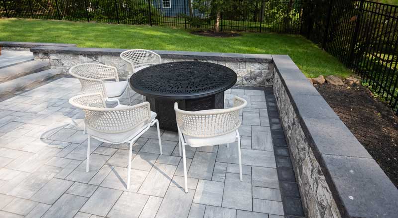 A patio in Summit NJ with firepit and additional wall seating.