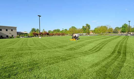 Large commercial lawn being mowed