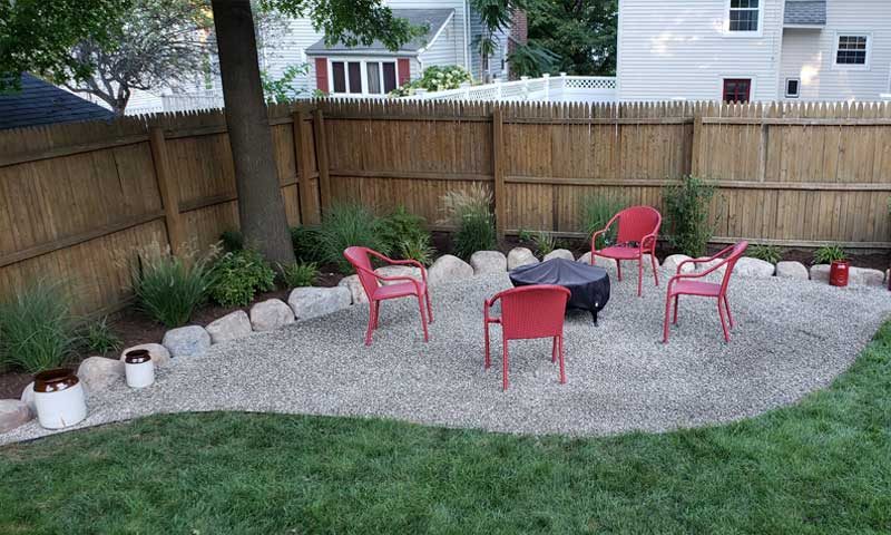 backyard-gravel-patio-with-outdoor-seating-and-firepit