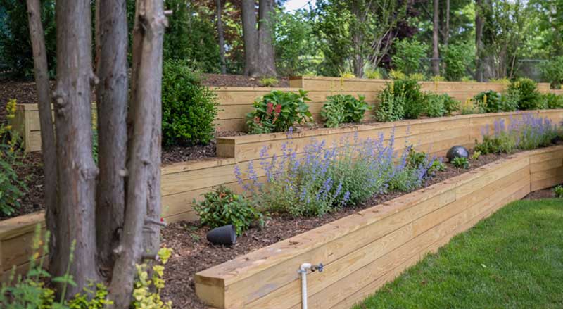 Tiered retaining walls with flowers and shrubs planted on each level