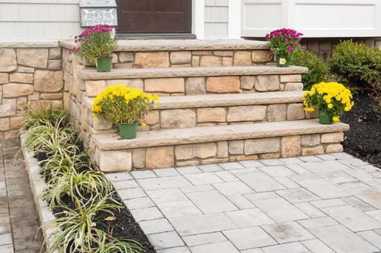 Outdoor stone masonry steps and patio with plantings