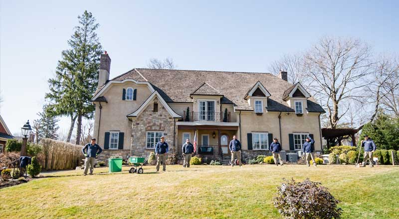 Landscape Solutions crew providing complete fall lawn care and winter prep services for a New Jersey home