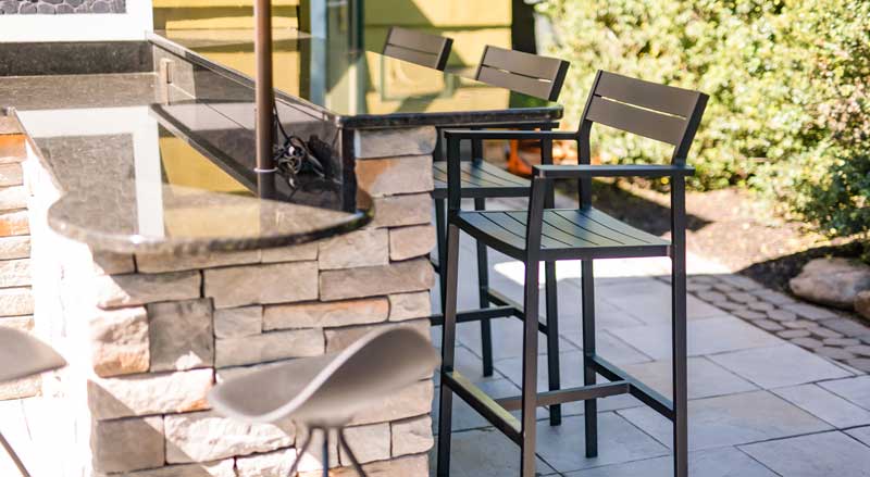 Stone outdoor bar with seating, an example of hardscape features that often require permits
